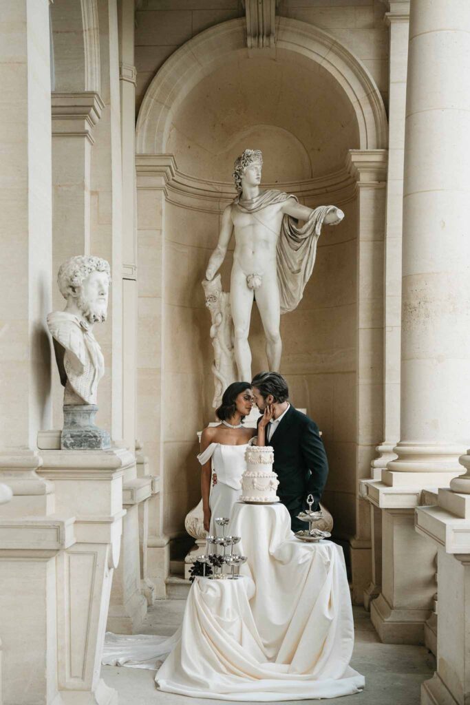 Chateau de Ferrieres Avecamour bride groom kissing cake champagne glass tower oysters big vintage statue background