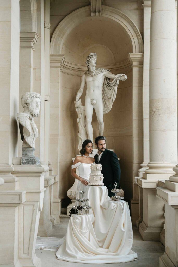 Chateau de Ferrieres Avecamour bride groom look away cake champagne glass tower oysters big vintage statue background