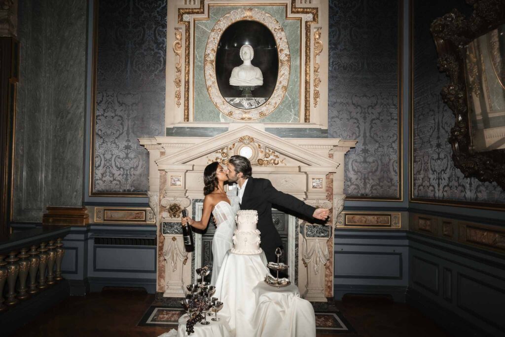 Chateau de Ferrieres Avecamour bride holding champagne bottle groom hug kiss reception