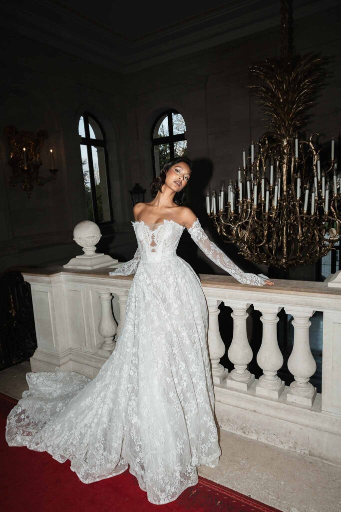 Chateau de Ferrieres Avecamour bride lace off shoulder ball gown red carpet vintage chandelier background