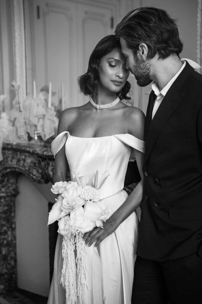 Chateau de Ferrieres Avecamour bride off shoulder dress holding bouquet groom forehead