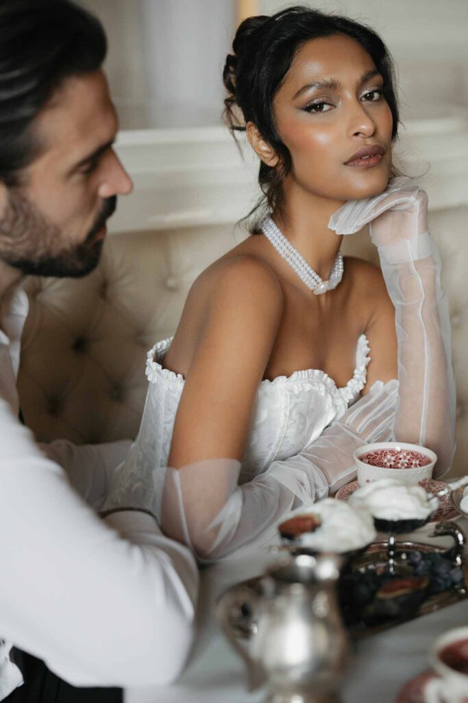 Chateau de Ferrieres Avecamour bride sitting beside groom sheer long gloves pearl necklace
