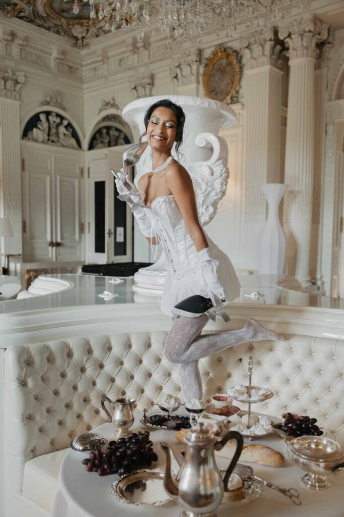 Chateau de Ferrieres Avecamour bride vintage short dress long lace stockings holding pointed silver shoes reception chair