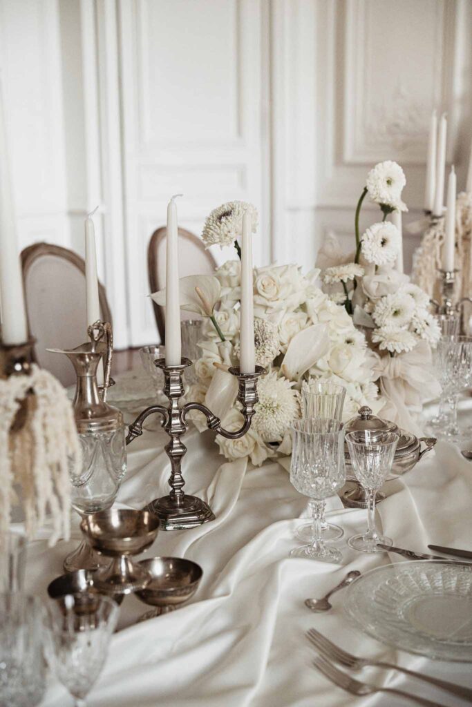 Chateau de Ferrieres Avecamour detail shot reception table silver candle holder glassware plates flowers
