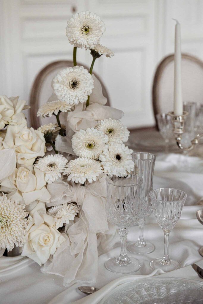 Chateau de Ferrieres Avecamour detail shot white floral arrangement reception table champagne glasses