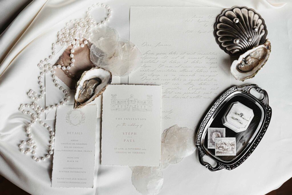 Chateau de Ferrieres Avecamour flatlay invitation white silver tray pearls rings