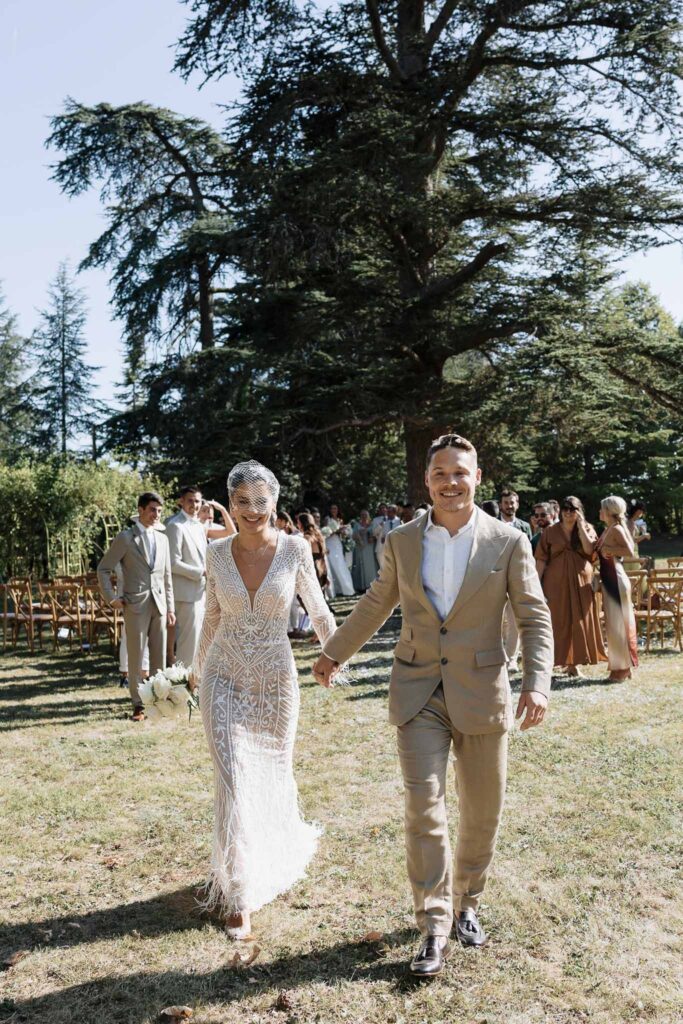 Chateau de Maillac Ala Breskaya bride groom holding hands ceremony aisle