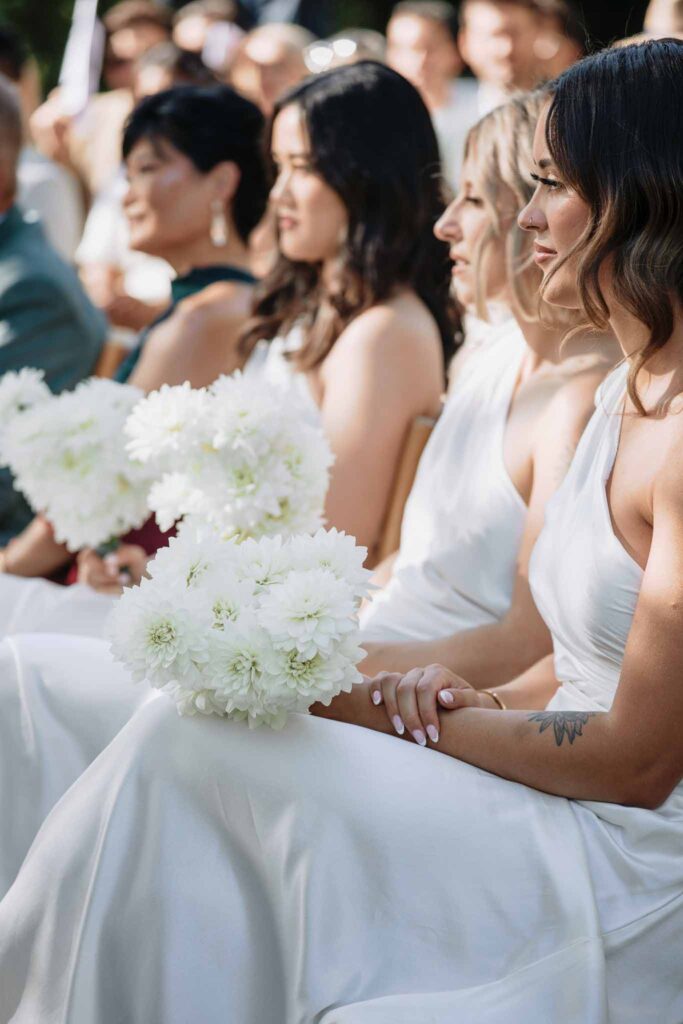 Chateau de Maillac Ala Breskaya bridesmaids seated ceremony holding bouquet