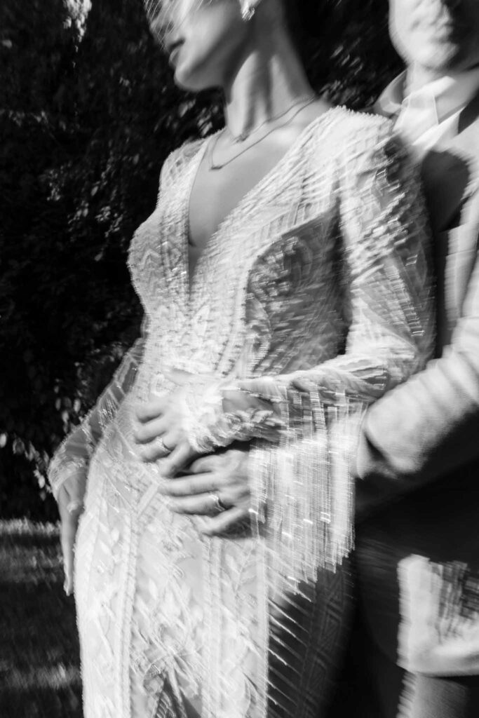 Chateau de Maillac Ala Breskaya groom hugging bride sparkle fringe dress black white photo blurry