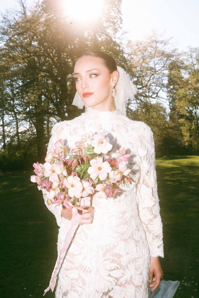 Chateau de la gruerie bride clean up do hair holding bouquet sunlight film camera