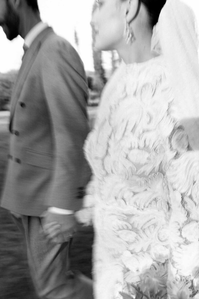 Chateau de la gruerie bride groom holding hands walking black white photo