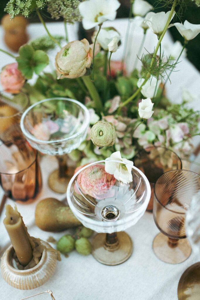 Chateau de la gruerie detail shot colored glasses flower arrangement reception table