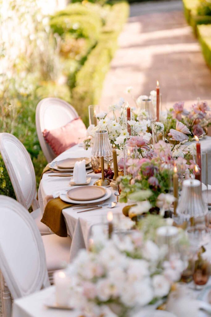Chateau de la gruerie detail shot reception table floral centerpiece white chair candles