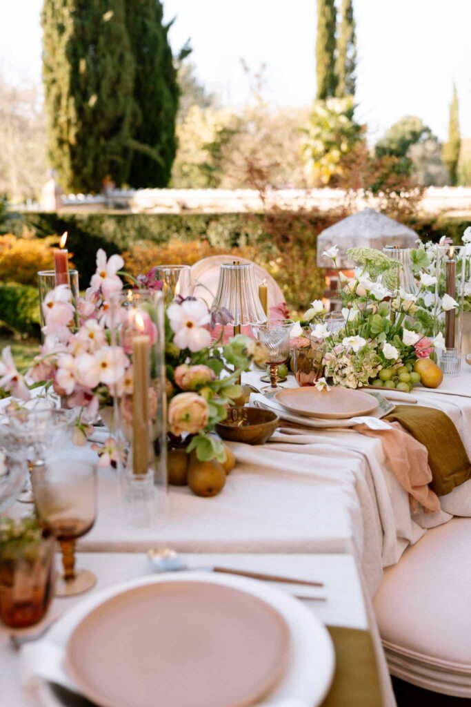Chateau de la gruerie detail shot reception table pink theme plates candles lamps