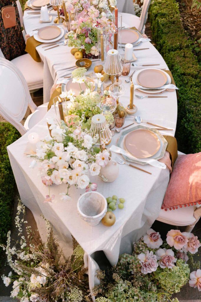 Chateau de la gruerie detail shot reception table pink theme plates candles lamps top view