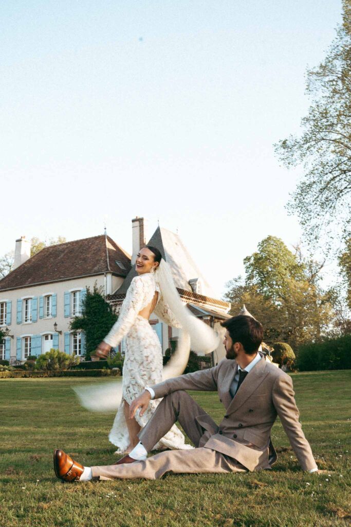Chateau de la gruerie groom sitting grass bride twirling garden area