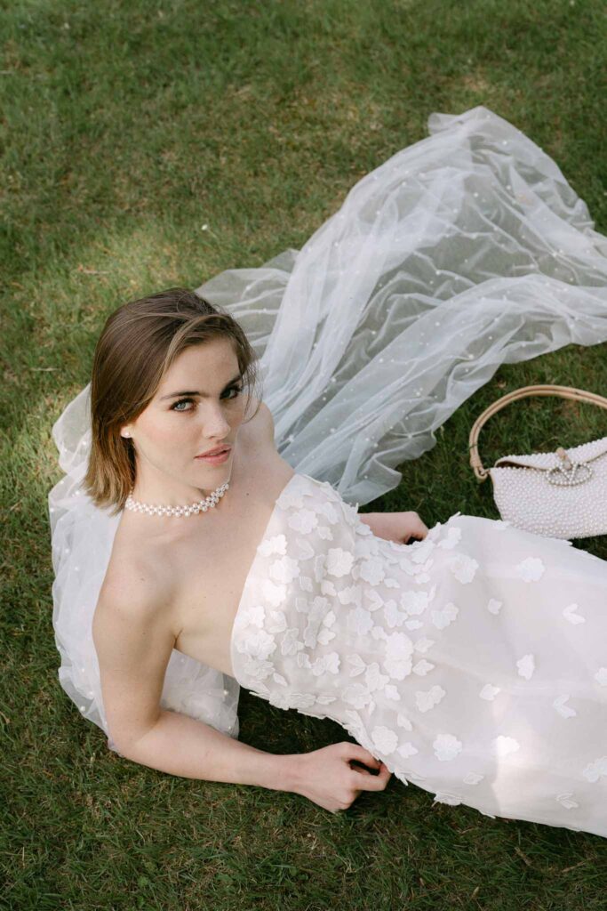 Chateau sainte claire keith flament bride lying grass short dress long veil