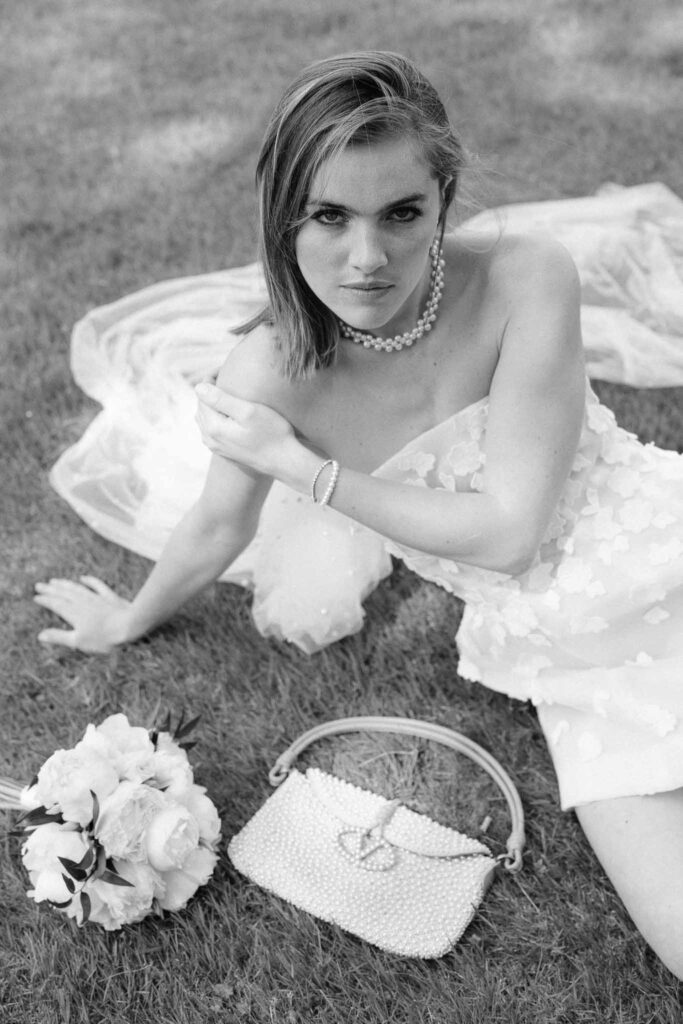 Chateau sainte claire keith flament bride lying grass short dress long veil black white photo