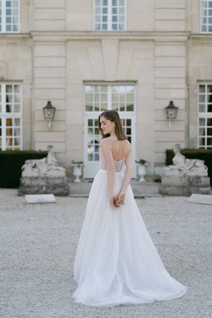 Chateau sainte claire keith flament bride strapless corset tulle dress back shot venue background