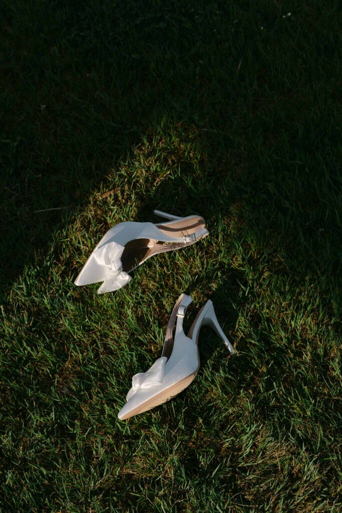 Chateau sainte claire keith flament detail shot pointed ribbon bride shoes grass