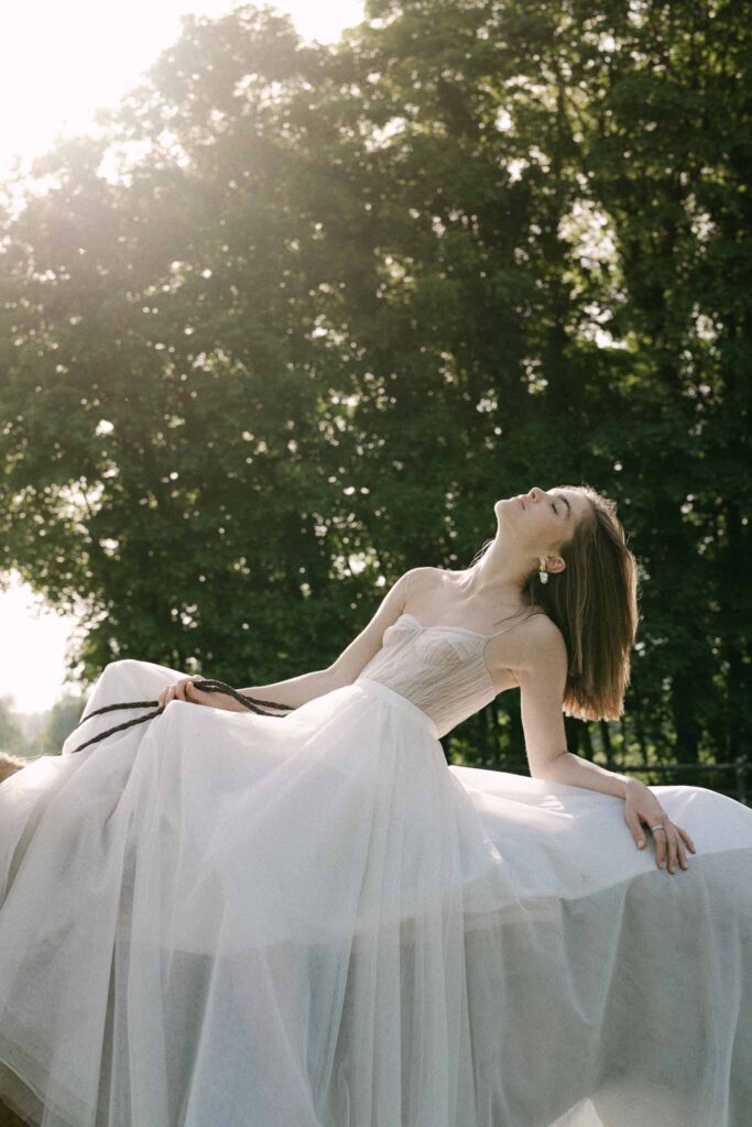 Chateau sainte claire keith flament short hair bride flowy dress leaning riding horse field