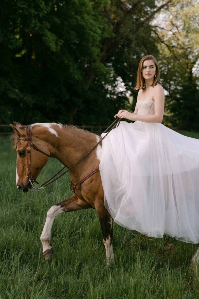 Chateau sainte claire keith flament short hair bride flowy dress riding horse field grass