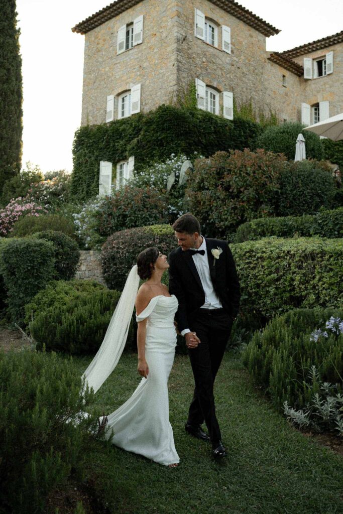 manoir de letang myrto events bride groom holding hand looking each other walking garden venue