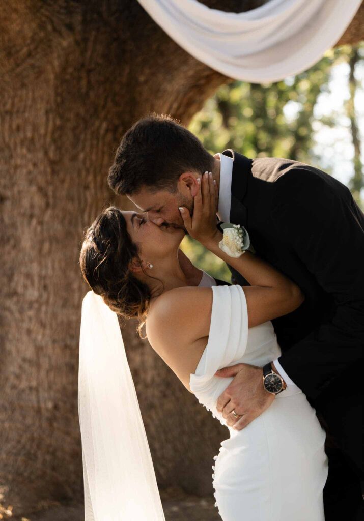 manoir de letang myrto events bride holding face groom kissing ceremony altar
