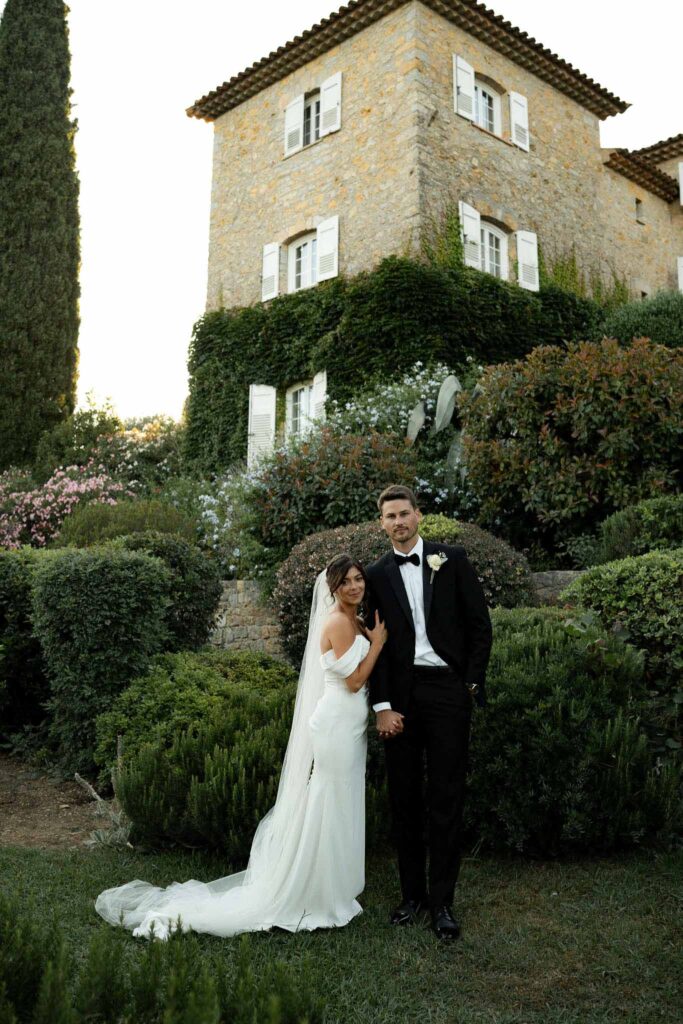 manoir de letang myrto events bride hugging groom arms long veil garden area