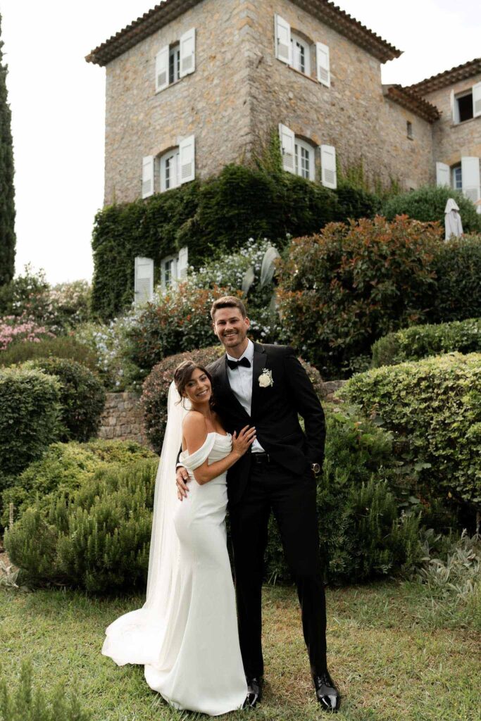 manoir de letang myrto events bride hugging groom garden area venue