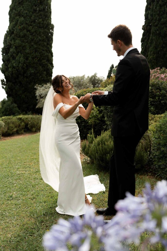 manoir de letang myrto events groom bride holding hands dancing garden area