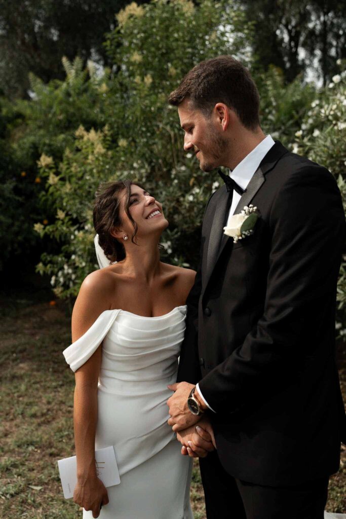 manoir de letang myrto events groom bride holding hands looking each other under a tree