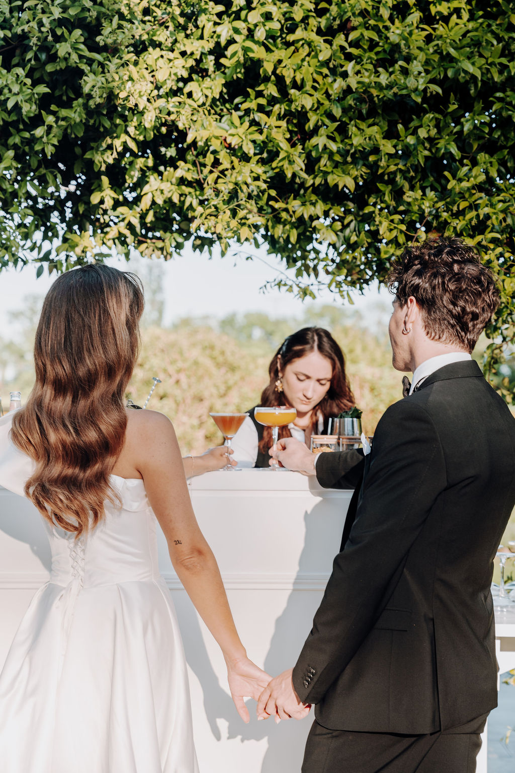 Chateau Couffin Marion Alexandra bride groom holding hands getting cocktail at bar