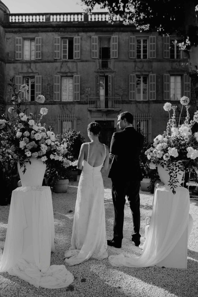 Chateau de Robernier Elise Morgan bride groom holding hands ceremony altar black white photo