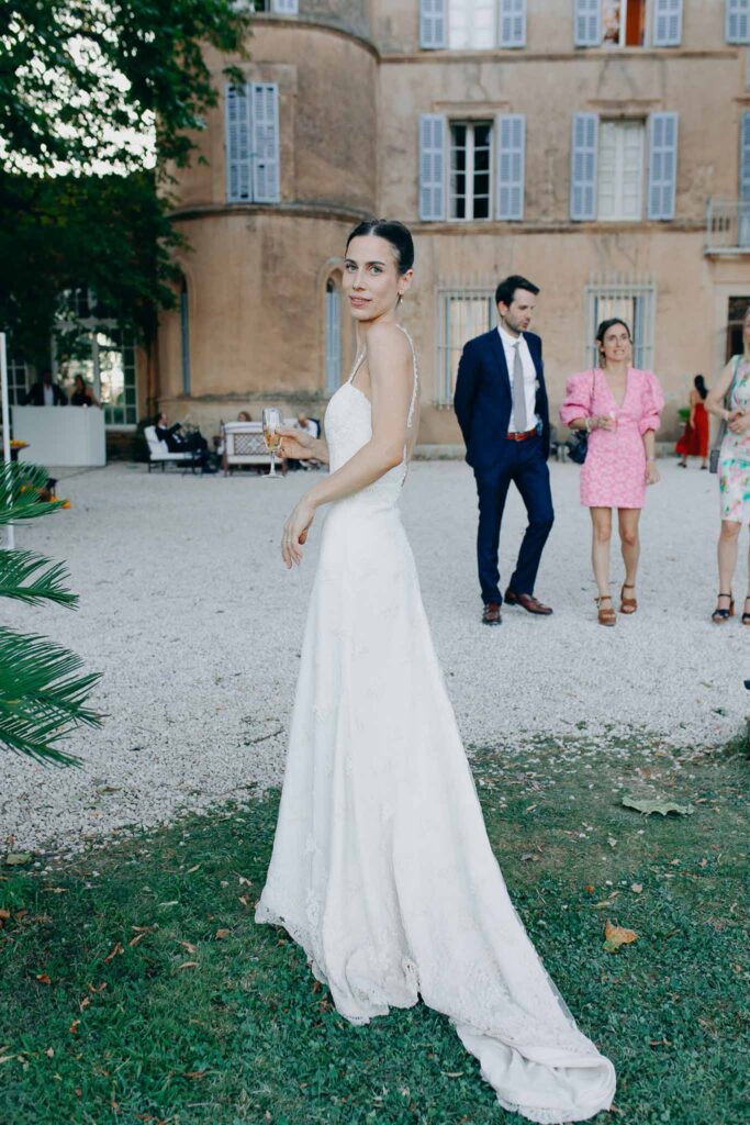 Chateau de Robernier Elise Morgan bride holding champagne glass long trail dress