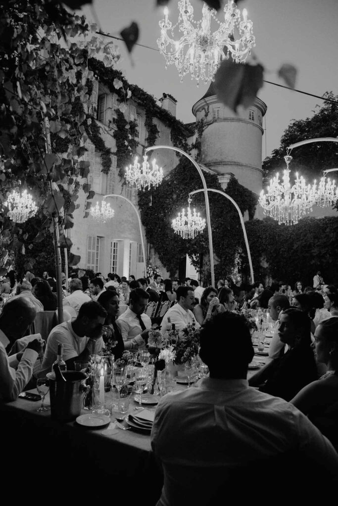 Chateau de Robernier Elise Morgan guests seated reception table black white photo night