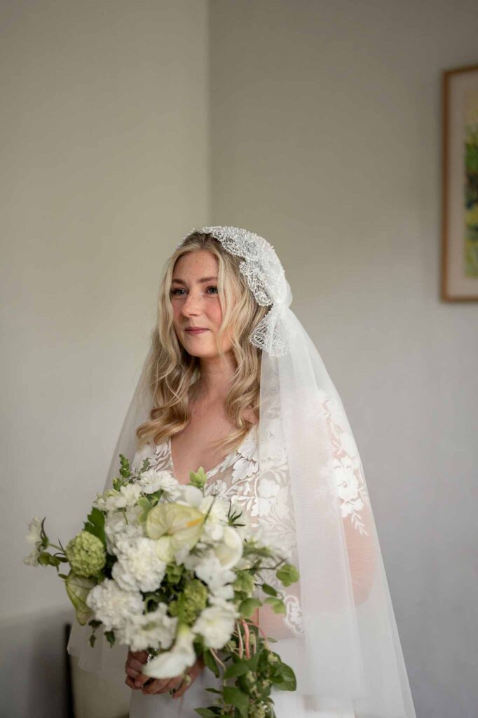 MCaelicia Galinier Lourmarin bride get ready vintage lace veil holding bouquet face