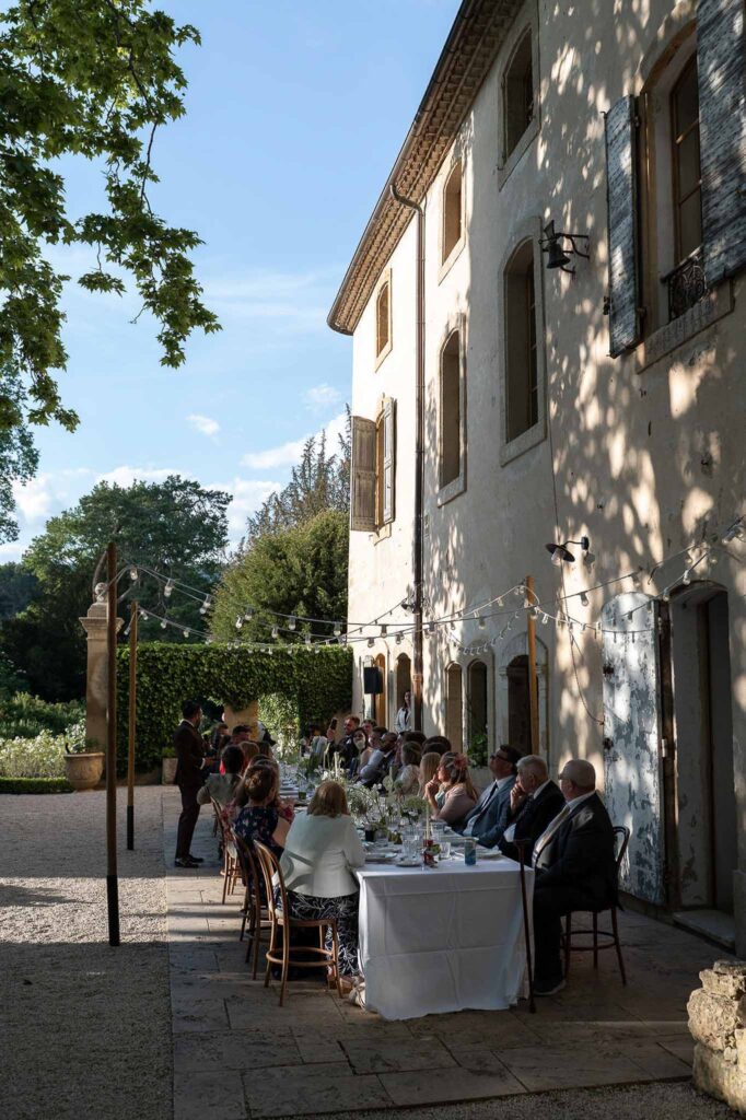 MCaelicia Galinier Lourmarin detail shot long reception table guests seated
