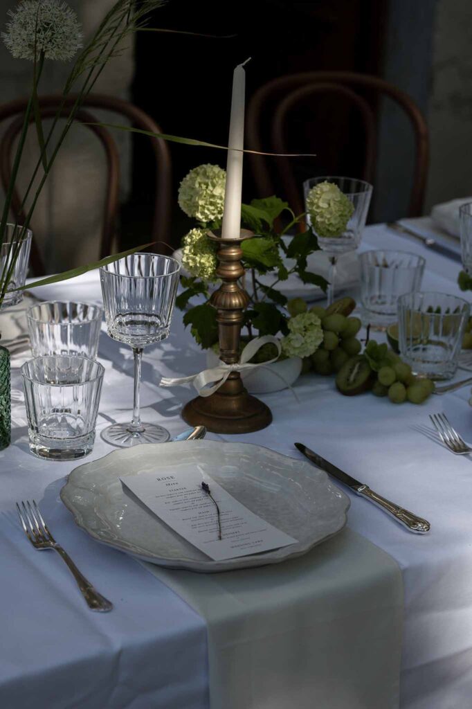 MCaelicia Galinier Lourmarin detail shot long reception table stringlights menu card