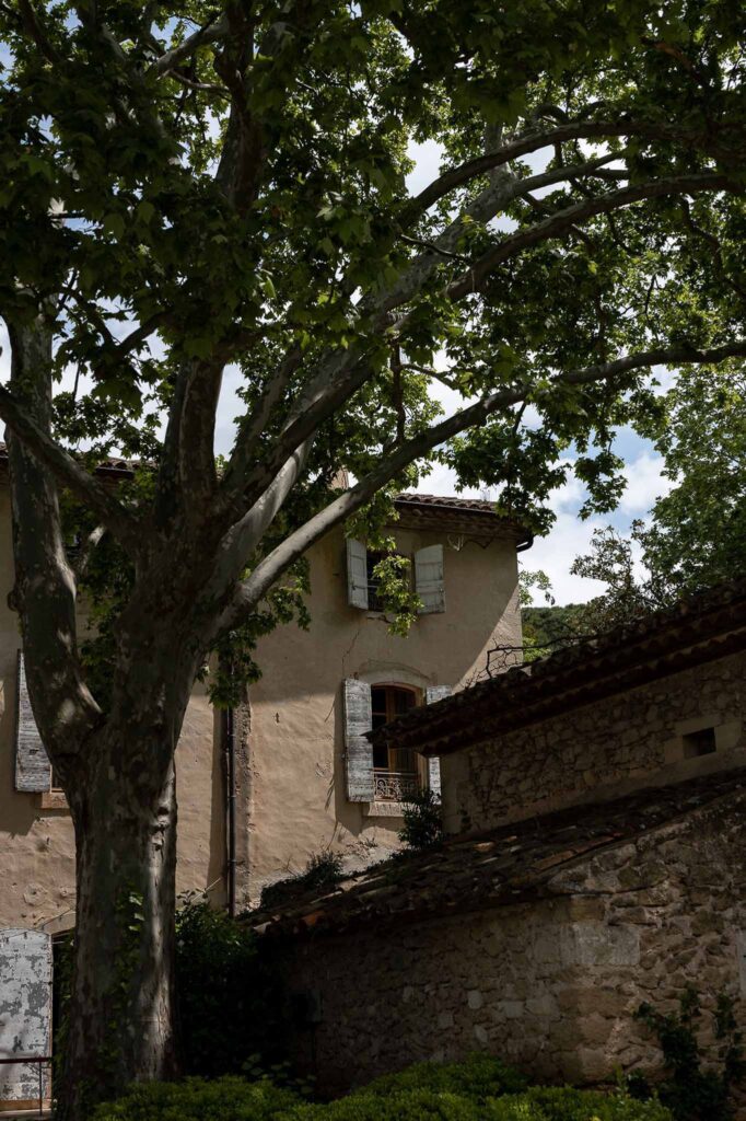 MCaelicia Galinier Lourmarin detail shot venue building roof old stone trees