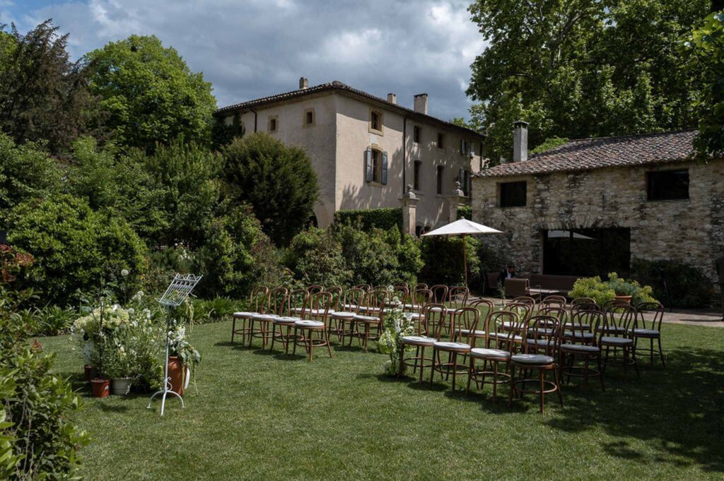 MCaelicia Galinier Lourmarin detail shot venue ceremony garden wood chairs