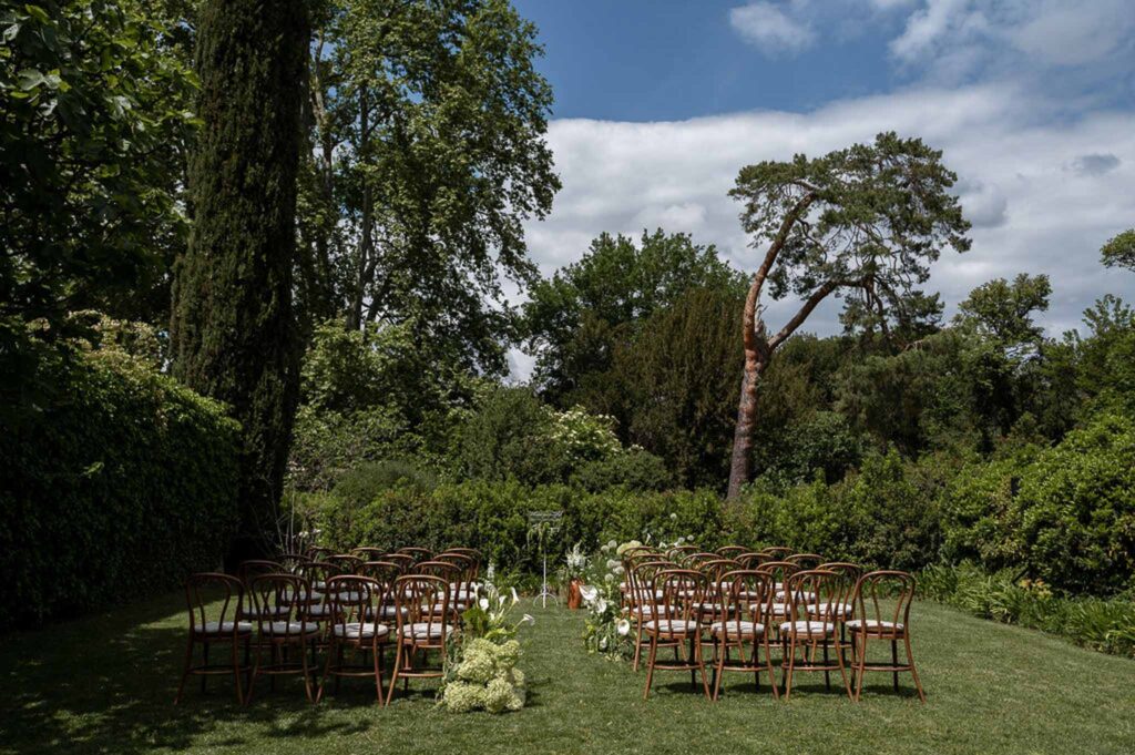 MCaelicia Galinier Lourmarin detail shot venue ceremony garden wood chairs back
