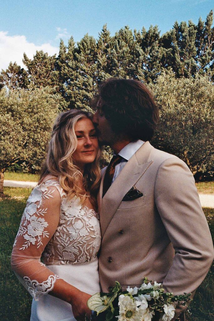 MCaelicia Galinier Lourmarin groom kiss bride forehead hug close up