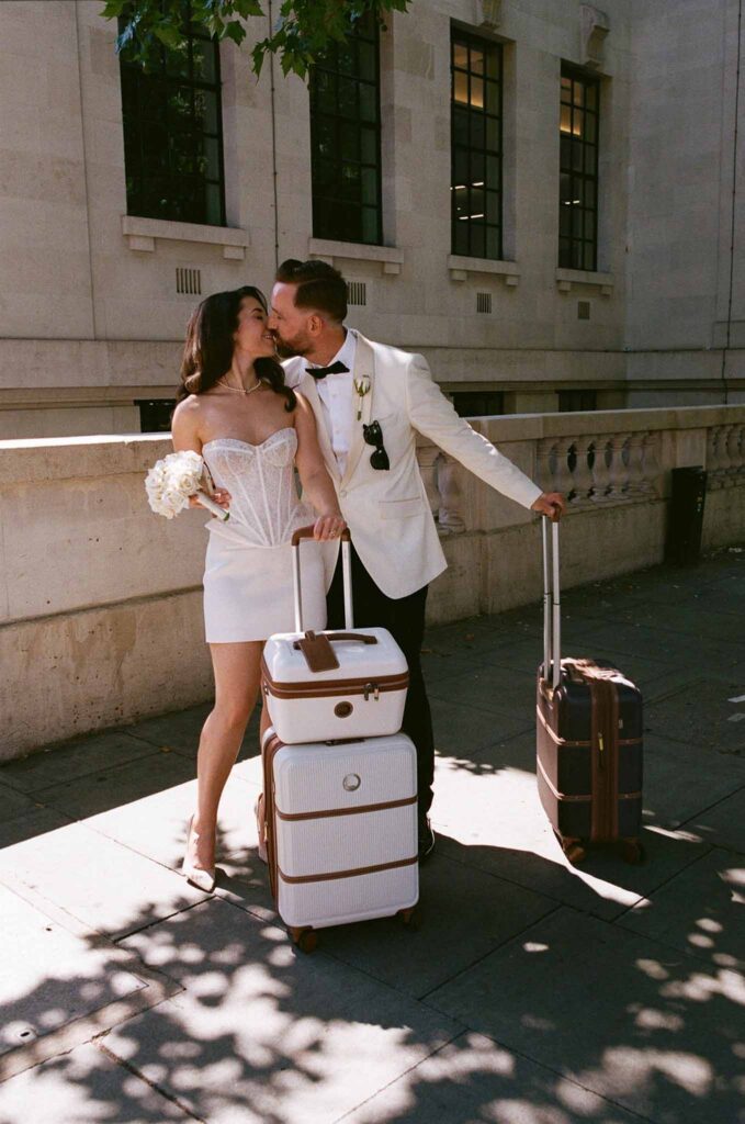 Boat in Paris Joan Jellet bride groom kissing holding lagguages