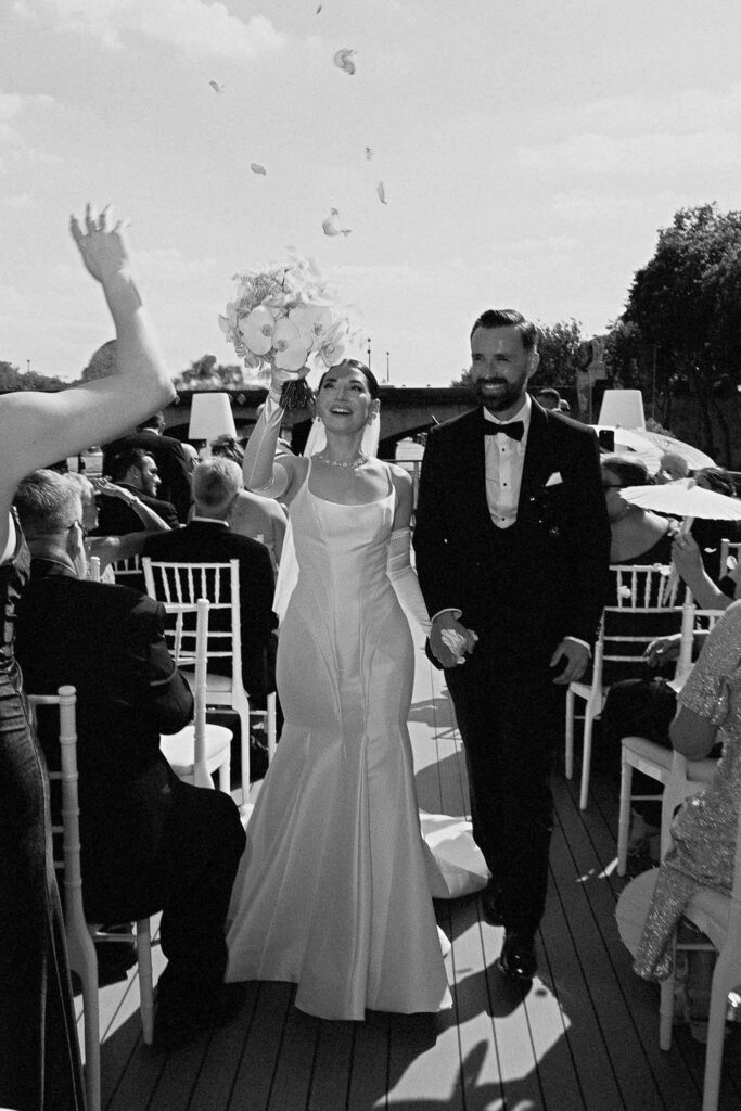 Boat in Paris Joan Jellet bride groom walking down aisle petal toss