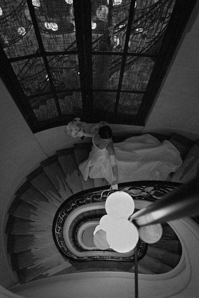 Boat in Paris Joan Jellet bride walking down vintage spiral hotel stairs black white