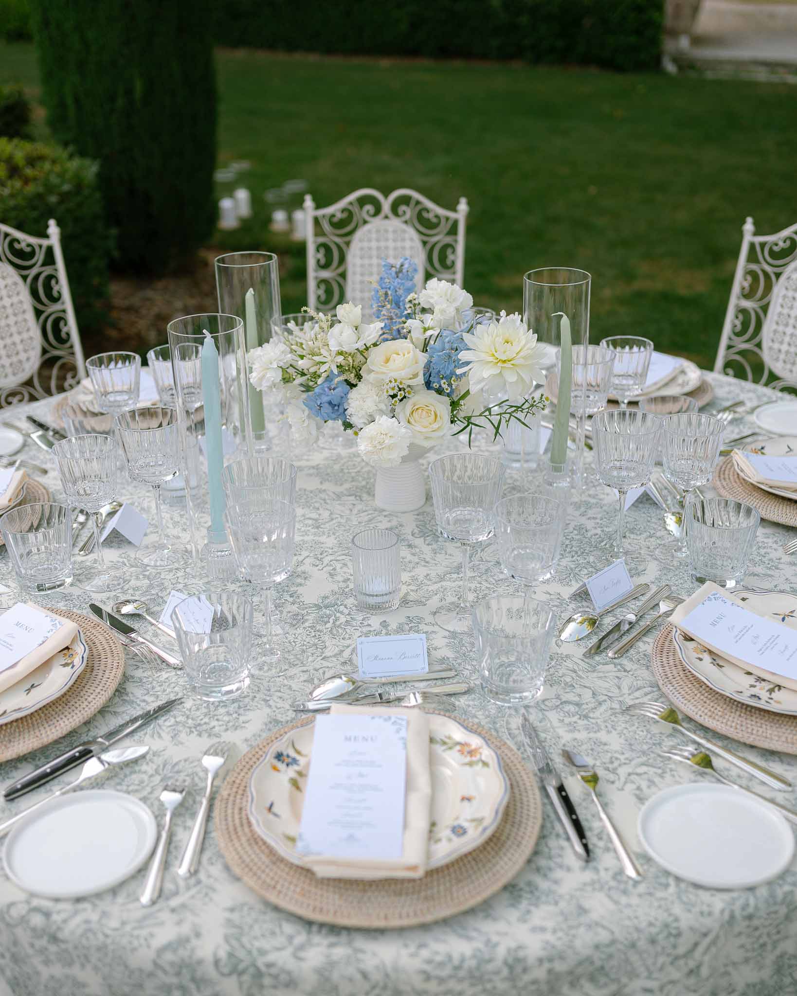 Wedding reception table setting in a garden with white roses