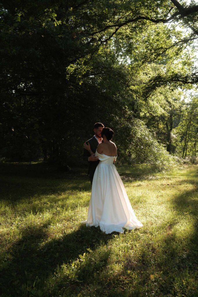 Chateau de Glairans Labricole bride groom hugging kiss forest sunlight