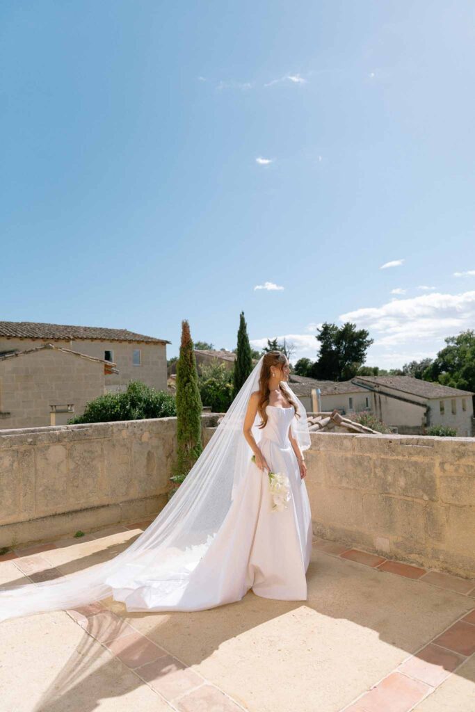 Chateau de Pondres Angie Graphy bride corset dress long trail veil balcony sunlight