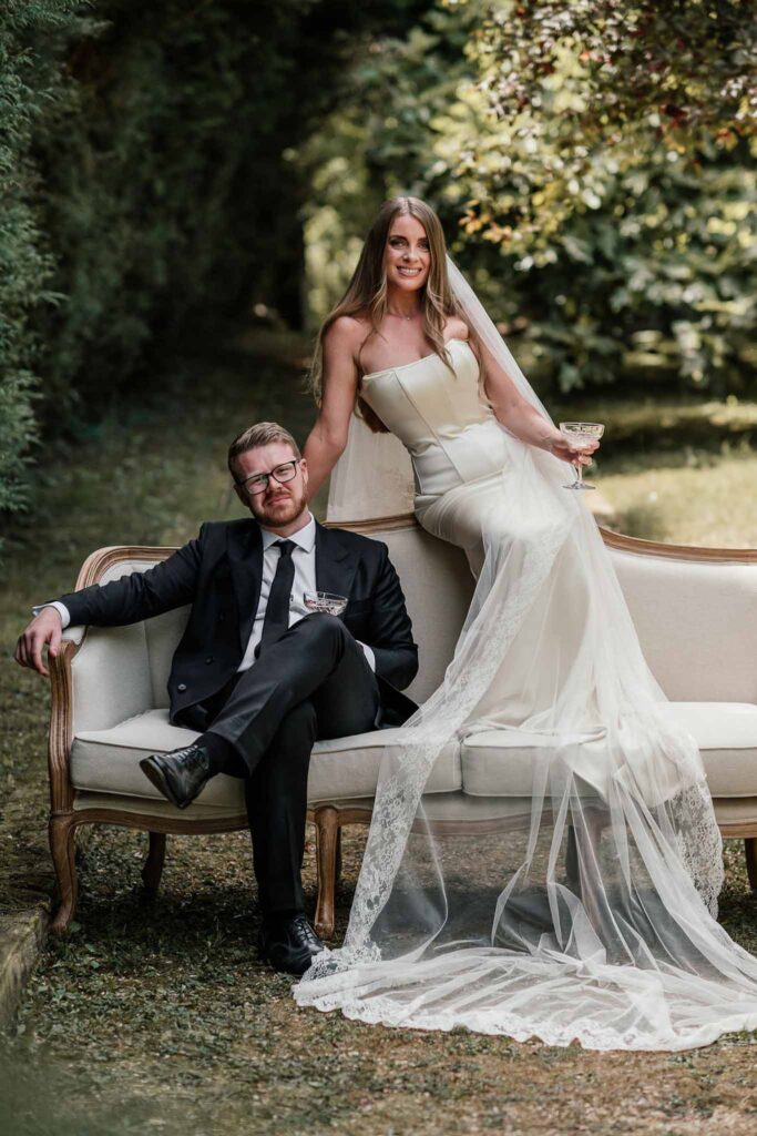 du Raysse W.Towell bride groom sitting vintage sofa outside garden
